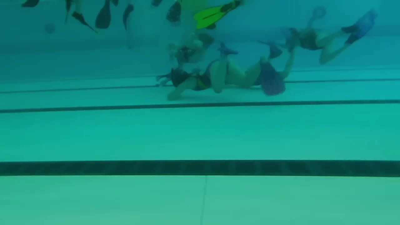 Junior underwater hockey players during a match